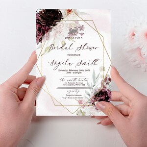 May include: A white bridal shower invitation with a gold geometric frame and floral design. The text reads "Join us for a Bridal Shower to honour Angela Smith, Saturday, February 20th, 2021, 2:00-4:00 pm, the Smith Bistor, 111 Autumn Avenue, Minneapolis, MN 55432, Registry: Target & Amazon".