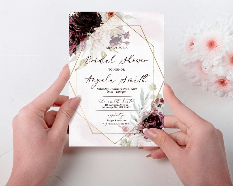 May include: A white bridal shower invitation with a gold geometric frame and floral design. The text reads "Join us for a Bridal Shower to honour Angela Smith, Saturday, February 20th, 2021, 2:00-4:00 pm, the Smith Bistor, 111 Autumn Avenue, Minneapolis, MN 55432, Registry: Target & Amazon".
