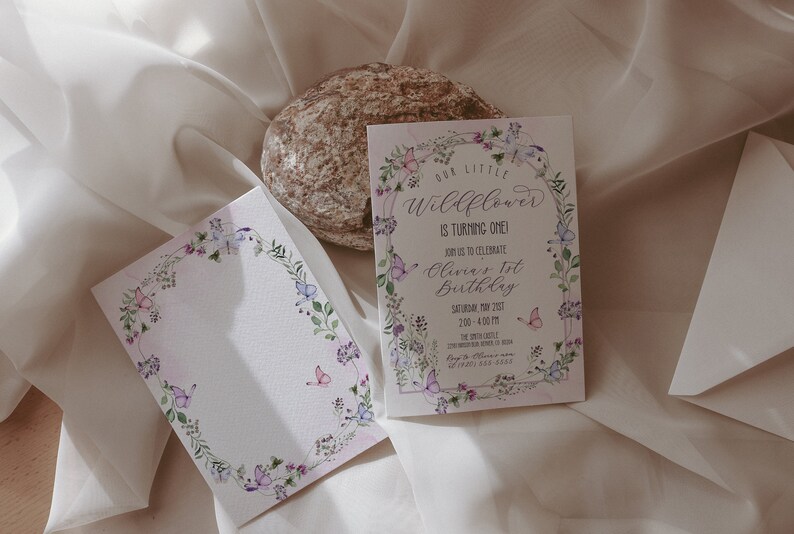 May include: A floral-themed invitation with butterflies and greenery surrounding the text "Our Little Wildflower is Turning One!"  Join us to celebrate Olivia's 1st Birthday, Saturday, May 2021, 2:00 - 4:00 PM. The Sprout Little, 123 Main Street, Anytown, USA. RSVP: 555-555-5555.