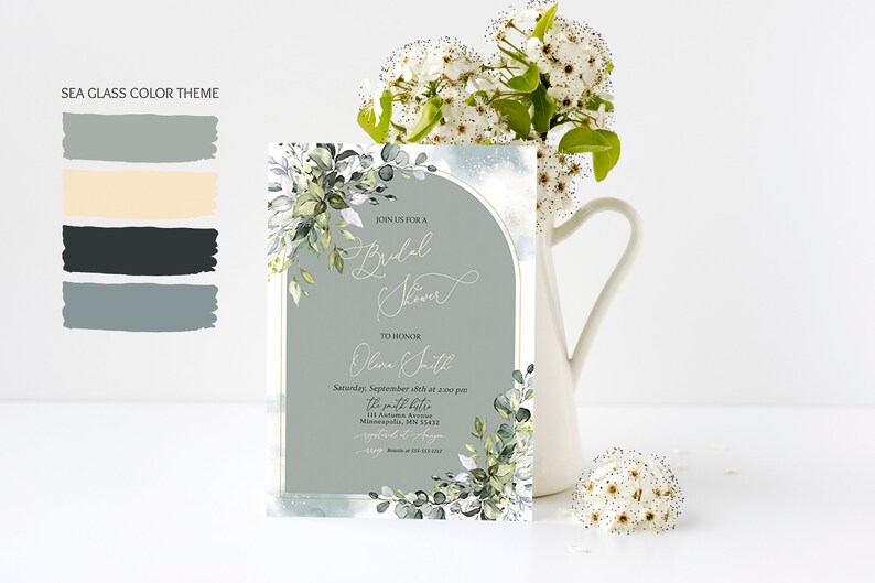 May include: A light blue and white bridal shower invitation with a gold border and a watercolor floral design. The invitation reads "Join us for a Bridal Shower to honor Olive Smith, Saturday, September 18th at 2:00 pm, The Smith Bistro, 111 Autumn Avenue, Minneapolis, MN 55422, RSVP by August 15th".