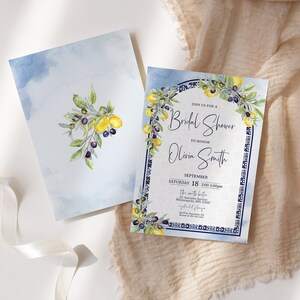 May include: Two watercolor invitations with a bridal shower theme. One features a lemon and olive branch design on a light blue background. The other invitation has the text "Join us for a Bridal Shower to Honor Olivia Smith".