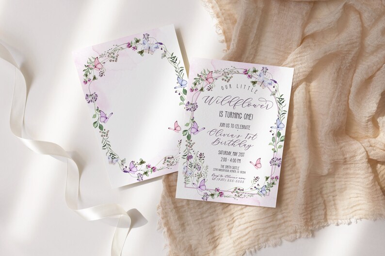 May include: A floral-themed birthday invitation with a watercolor design featuring butterflies and flowers. The text reads "Our Little Wildflower is turning one! Join us to celebrate Olivia's 1st Birthday. Saturday, May 21st, 2:00 - 4:00 PM. The Smith Castle, 1234 Smith Street, Anytown, CA 12345. RSVP to 123-456-7890."