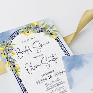 May include: Bridal shower invitation with watercolor lemon and olive branch design. The invitation features the text "Join us for a Bridal Shower to Honor Olivia Smith" and event details. A gold ribbon is draped across the invitation.