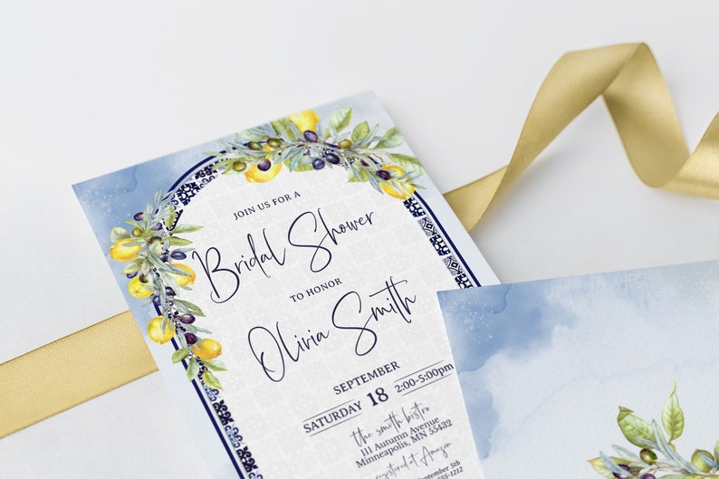 May include: Bridal shower invitation with watercolor lemon and olive branch design. The invitation features the text "Join us for a Bridal Shower to Honor Olivia Smith" and event details. A gold ribbon is draped across the invitation.