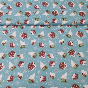 May include: Light blue fabric with a repeating pattern of snow-covered houses and snowflakes. The houses have red roofs, green doors, and white snow. A festive, winter-themed fabric.