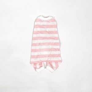 The flatlay of the Pink & White Striped onesie shows white cuffs on the hems and a frill around the neckline.