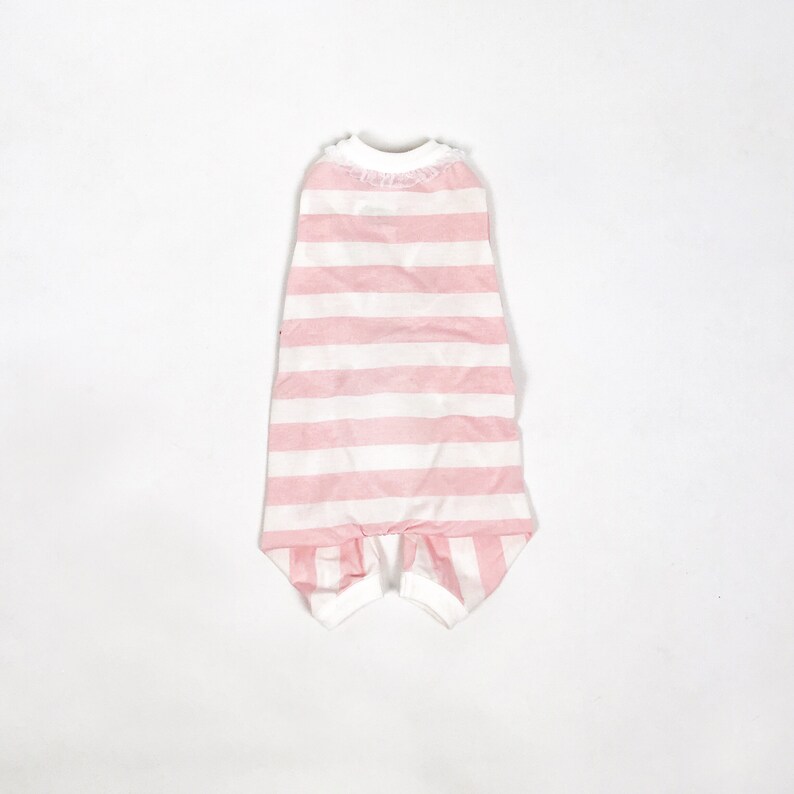 The flatlay of the Pink & White Striped onesie shows white cuffs on the hems and a frill around the neckline.