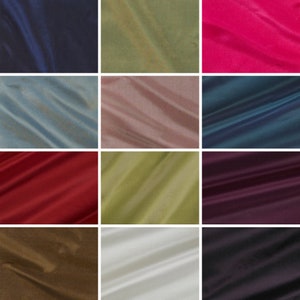 May include: A collection of 12 fabric swatches in various colors, including navy blue, green, pink, blue, brown, red, white, and black. The fabric has a smooth, silky texture.