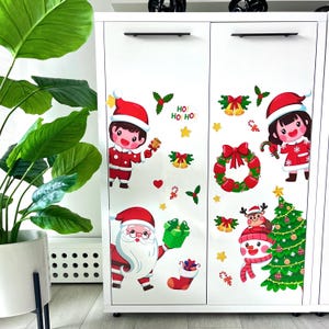 Festive Window Sticker with Santa, Snowman, Christmas Tree, and Kids Dressed as Santa Claus. A Charming Decoration That Brings Holiday Magic
