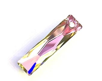 May include: A clear crystal pendant with a pink and yellow iridescent finish. The pendant has a small hole at the top for hanging.