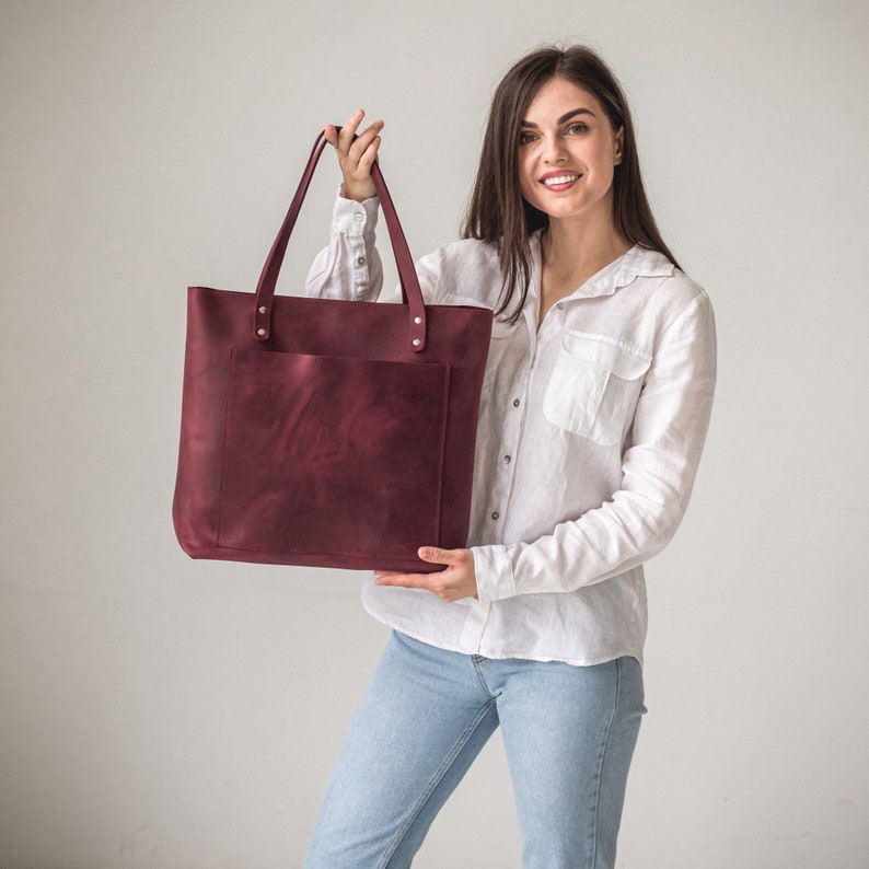 Burgundy leather tote bag with zipper and outside pocket