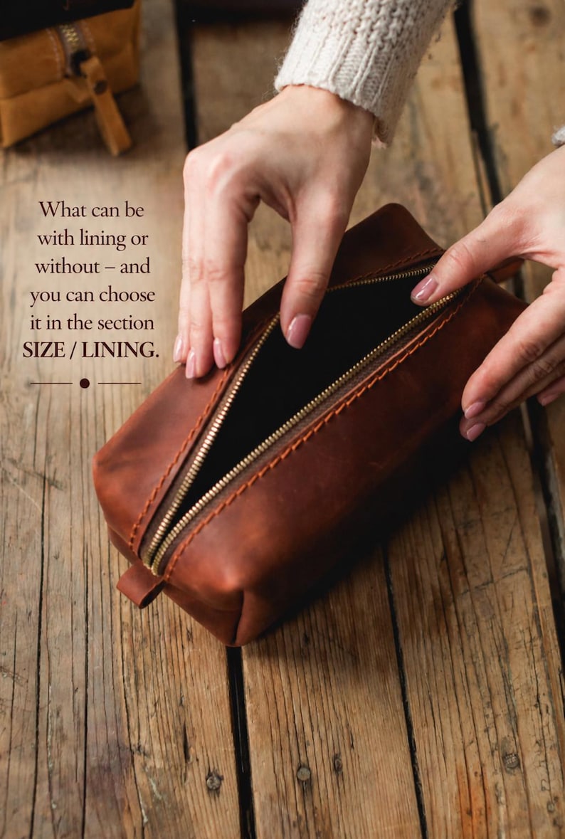 May include: A brown leather rectangular pouch with a gold zipper is open, revealing a black interior. The text "What can be with lining or without - and you can choose it in the section SIZE / LINING" is visible. The pouch is on a wooden surface.