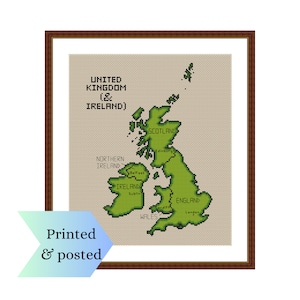 May include: A cross-stitch pattern of the United Kingdom and Ireland, with the countries labelled in black text. The pattern is framed in a brown wood frame.
