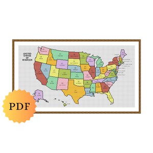 May include: A framed cross-stitch pattern of the United States of America map featuring multicolored states with black text abbreviations and the title UNITED STATES OF AMERICA in the top left corner, accompanied by a yellow starburst PDF icon.
