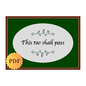 Può includere: Design a punto croce con la frase "This too shall pass" in corsivo nero su un ovale bianco, incorniciato in verde e marrone. Sono inclusi elementi floreali decorativi e un badge "PDF".