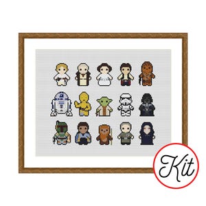 May include: A framed cross-stitch kit featuring 15 Star Wars characters in a pixelated style. The characters include Luke Skywalker, Darth Vader, and Yoda. The kit is in a wooden frame with the word "Kit" in a red circle.