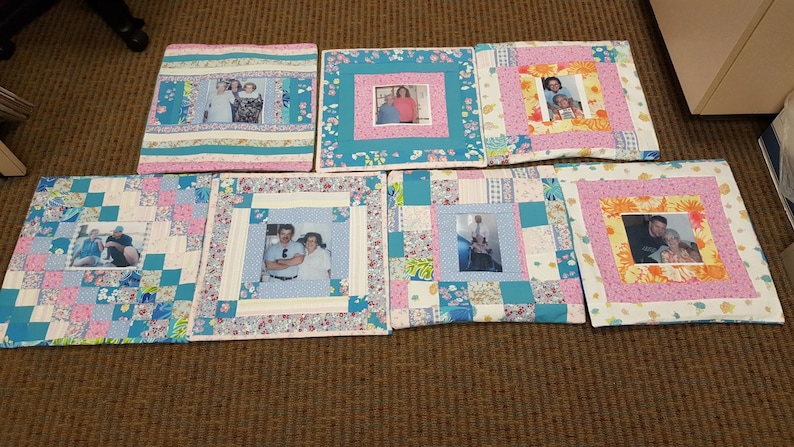 May include: Seven square quilted pillow covers with different patterns and colors. Each pillow cover features a framed photo of a couple. The pillow covers are made with a variety of fabrics, including floral prints, plaid, and solid colors.