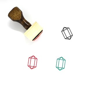 Puede incluir: Un sello de madera con un mango y una base rectangular. El sello presenta un contorno negro de una forma geométrica, similar a un cristal o una piedra preciosa. El sello se muestra con tres versiones de color diferentes del diseño: negro, rojo y verde.