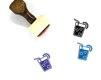 May include: Wooden rubber stamp with a black and white illustration of a glass of iced tea with a lemon wedge and two straws. The stamp is on a white background.