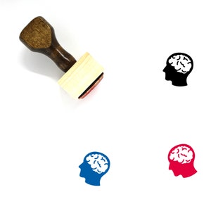May include: A wooden rubber stamp with a brown handle and a rectangular wooden block. The stamp features a black silhouette of a head with a brain inside. There are also three other versions of the stamp in blue, red, and black.