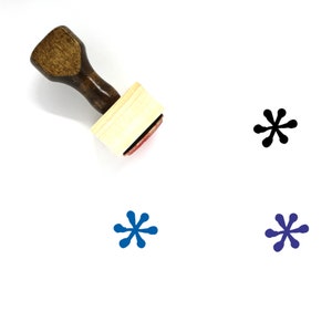 May include: A wooden stamp with a handle and a rectangular base. The stamp is designed to create a black, blue, or dark blue starburst pattern.