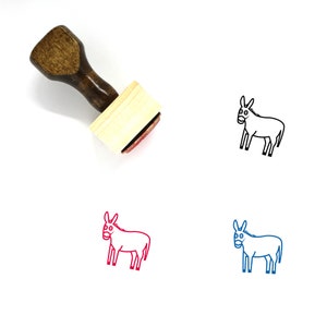 May include: A wooden rubber stamp with a brown handle and a rectangular base. The stamp features a black line drawing of a donkey with a red outline. The stamp is on a white background.