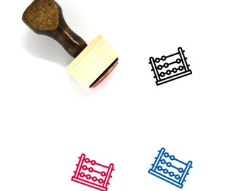 May include: A wooden stamp with a red ink pad. The stamp features a black line drawing of an abacus. There are three other images of the abacus in different colors: red, blue, and black.