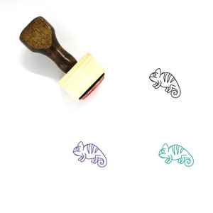 May include: Wooden rubber stamp with a brown handle and a rectangular base. The stamp features a black line drawing of a chameleon.