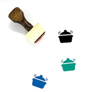May include: A wooden rubber stamp with a black, green, and blue pot with steam coming out of it. The stamp is on a white background.