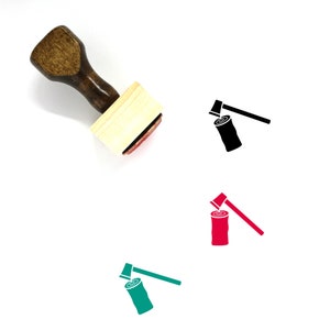 May include: A wooden stamp with a red ink pad. The stamp features a black silhouette of an axe chopping a log of wood.