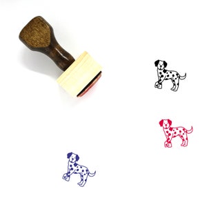 May include: A wooden rubber stamp with a brown handle and a rectangular block. The stamp features a black and white illustration of a Dalmatian dog.