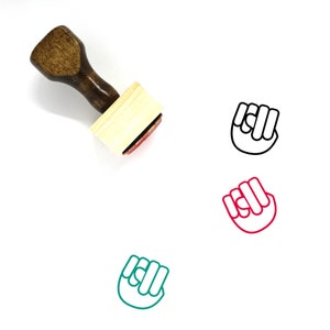 May include: A wooden stamp with a brown handle and a rectangular wooden block. The stamp features a black line drawing of a fist.