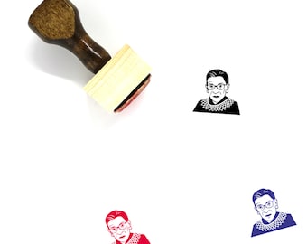 May include: A wooden rubber stamp with a black and white image of Ruth Bader Ginsburg. The stamp is on a white surface. There are three different colored versions of the image below the stamp.