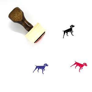 May include: A wooden rubber stamp with a black, blue, and red silhouette of a German Shorthaired Pointer dog. The stamp is on a white background.