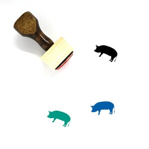 May include: A wooden rubber stamp with a pig silhouette design. The stamp is brown with a red ink pad. The pig is shown in black, blue, and green.