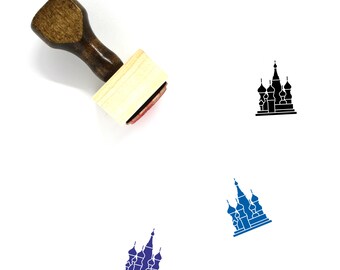 May include: A wooden rubber stamp with a brown handle and a rectangular base. The stamp features a black silhouette of St Basil's Cathedral in Moscow, Russia.