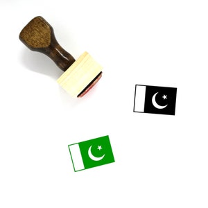May include: A wooden rubber stamp with a green and white Pakistani flag design. The stamp is on a white surface.