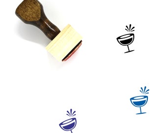 May include: Wooden rubber stamp with a handle and a square base. The stamp features a black silhouette of a champagne flute with a splash of liquid coming out of the top.