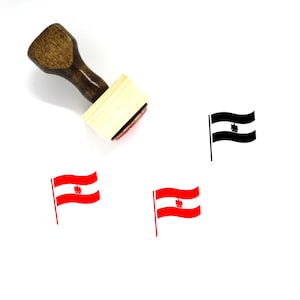 Puede incluir: Un sello de goma de madera con una almohadilla de tinta roja. El sello presenta una imagen en blanco y negro de una bandera con un &aacute;guila estilizada. La bandera ondea al viento. Hay otras dos im&aacute;genes de la bandera en rojo y blanco.
