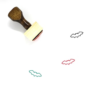 May include: A wooden rubber stamp with a brown handle and a rectangular wooden block. The stamp features a black outline of a bat. Three additional images of bats are shown in black, red, and green.
