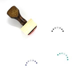 May include: A wooden stamp with a handle and a rectangular base. The stamp is used to create a design of a crescent moon with eight phases. The design is shown in black, blue, and green.