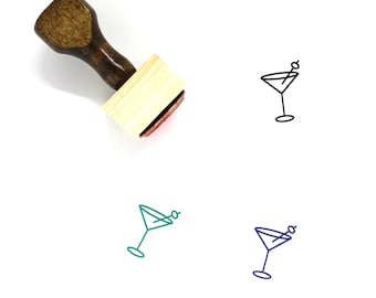May include: A wooden rubber stamp with a martini glass design. The stamp is brown with a light wood base. The martini glass is outlined in black ink.