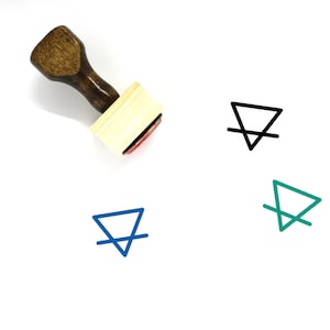 May include: A wooden rubber stamp with a brown handle and a rectangular base. The stamp features a black and white symbol of a triangle with a line through it.