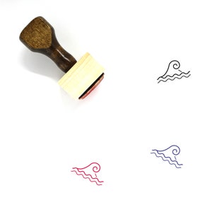May include: A wooden rubber stamp with a brown handle and a rectangular wooden block. The stamp features a black line drawing of a wave with a curl at the top.