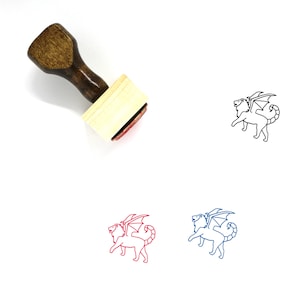 May include: Wooden rubber stamp with a brown handle and a rectangular base. The stamp features a black line drawing of a winged lion.