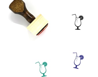 May include: A wooden rubber stamp with a handle and a rectangular base. The stamp features a black and white illustration of a cocktail glass with a straw and a lime wedge.