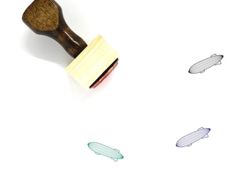 May include: A wooden rubber stamp with a red ink pad. The stamp features a black line drawing of an airship or blimp.