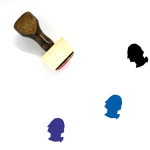 May include: A wooden rubber stamp with a brown handle and a rectangular wooden block. The stamp features a silhouette of a person's head in profile. The stamp is on a white background.