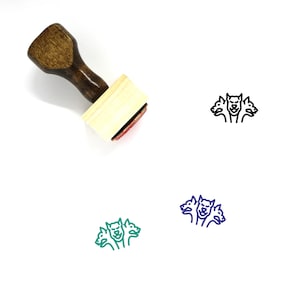 以下が含まれることがあります： ハンドルと長方形のベースが付いた木製ゴム印。スタンプには、3 つの頭を持つ犬の黒の線画が描かれています。