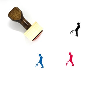 May include: A wooden stamp with a handle and a red ink pad. The stamp features a silhouette of a person urinating in blue, red, and black.